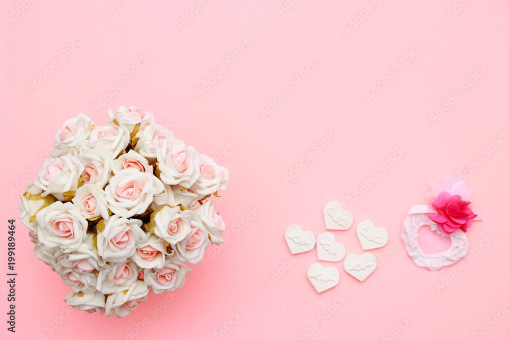 Heart symbol made of stone, white pink roses. Valentine's and mothers day background. Flat lay, top view