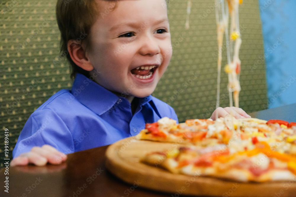 Child, boy, eating pizza at a restaurant, , summertime Child, boy, eating pizza at a restaurant, , summertime