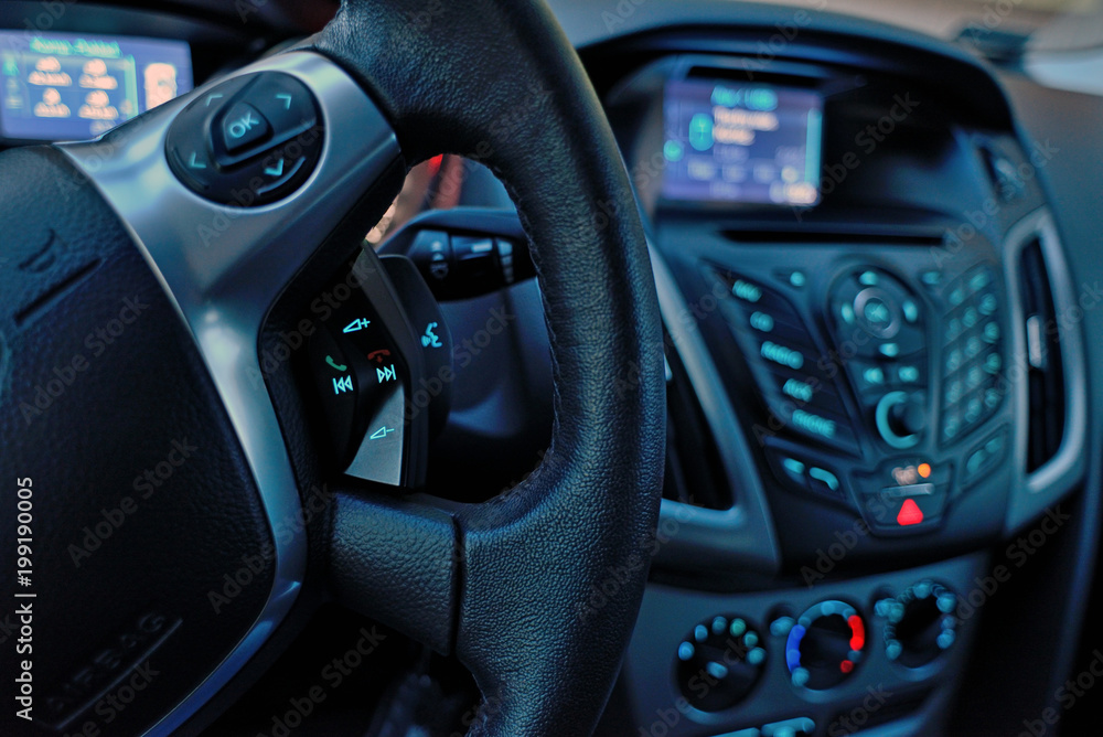 Car dashboard and steering wheel inside of car.