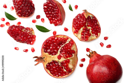 pomegranate fruit with green leaves isolated on a white background top view