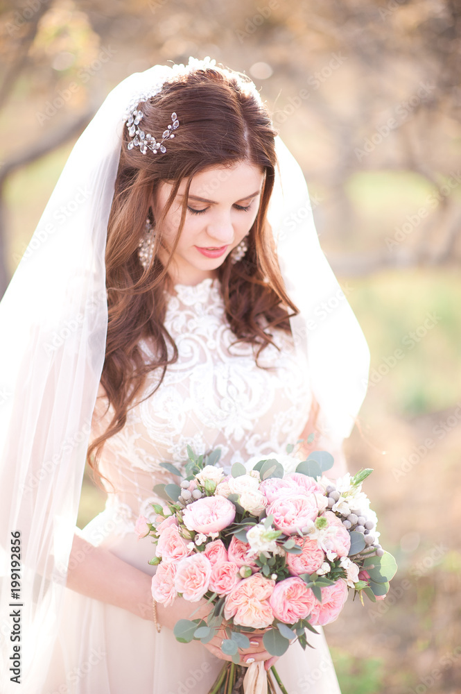 Beautiful bride girl holding flowers outdoors. Wedding day. 20s. Beautiful bride girl holding flowers outdoors. Wedding day. 20s.