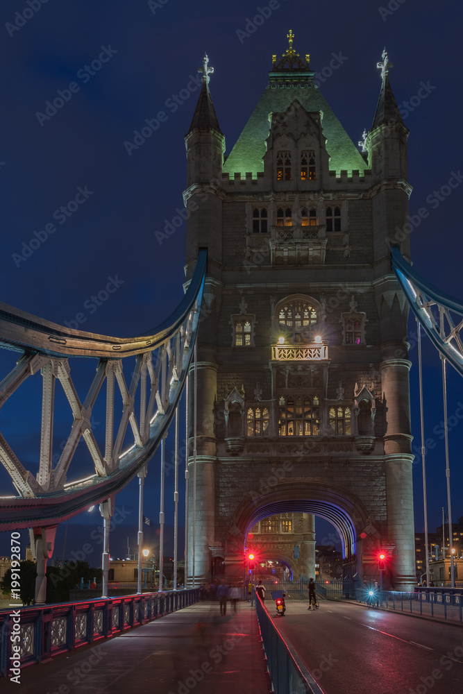 Obraz premium Tower Bridge in the night is opening for cruise and is closing for cars traffic , London, England.
