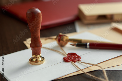 Old parchment or diploma scroll with wax seal and quill pen