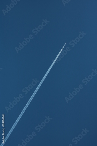 Airplane up in the sky diagonal to the right