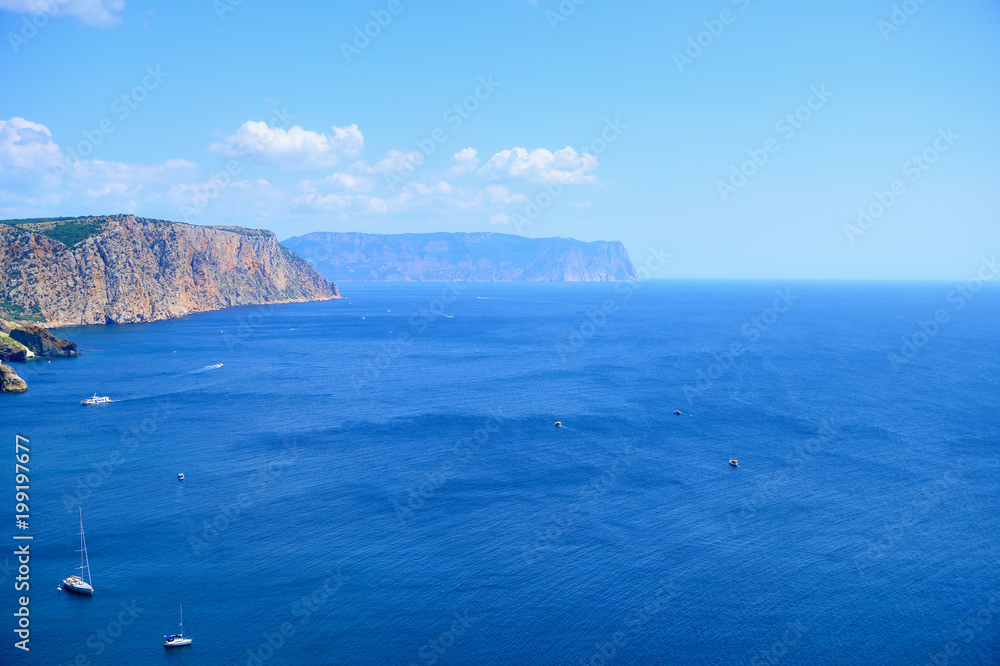 Fototapeta premium Seascape on a Sunny day. View of the sea and ships from the top of the mountain. Horizontal orientation