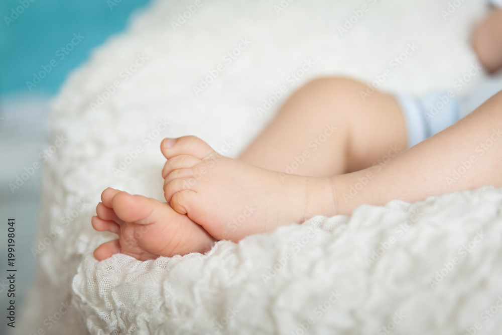 Cute children's legs on white blanket Cute children's legs on white blanket