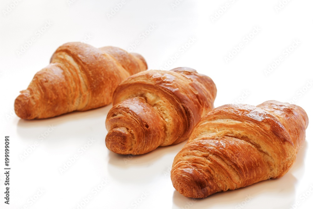 Homemade French Croissants isolated on white, selective focus