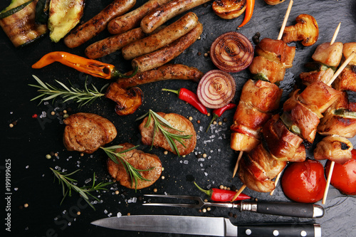 Assorted delicious grilled meat with vegetable on a barbecue photo