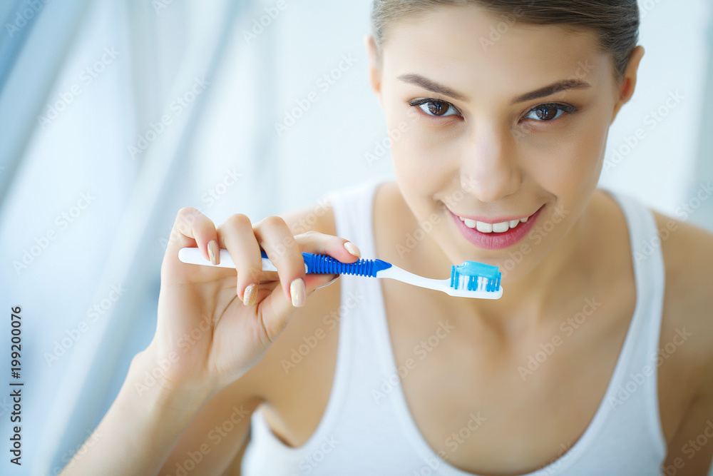 Beautiful Smiling Woman Brushing Healthy White Teeth With Brush. High Resolution Image Beautiful Smiling Woman Brushing Healthy White Teeth With Brush. High Resolution Image