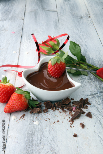 Valentine Chocolate fondue melted with fresh strawberries and dark chocolate and roses