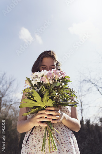 A loved girl holds flowers