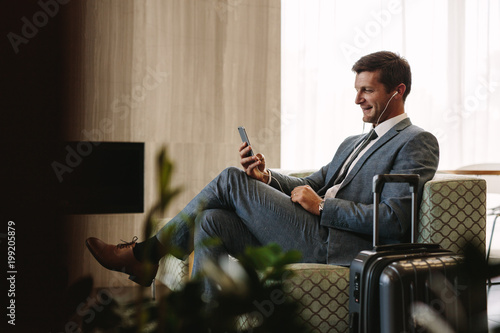 Business executive making a video call at airport lounge