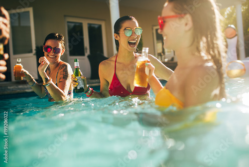 Photography Group of women having party in a swimming pool