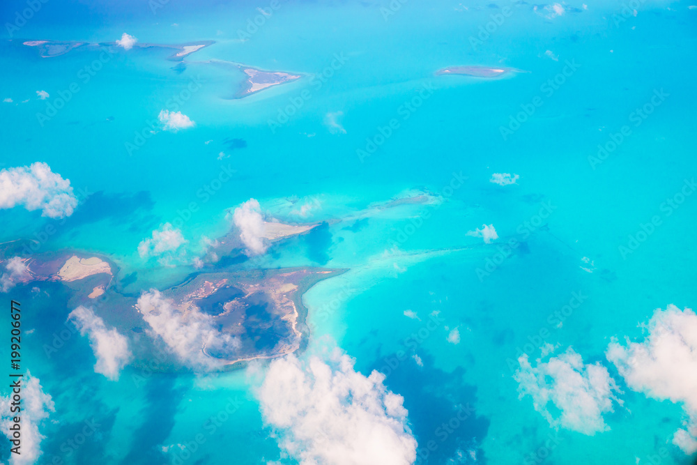Beautiful perfect view of exotic islands and turquoise water from airplane