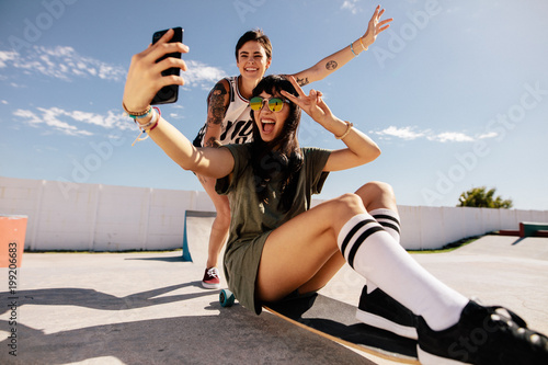 Girls skateboarding and taking selfie