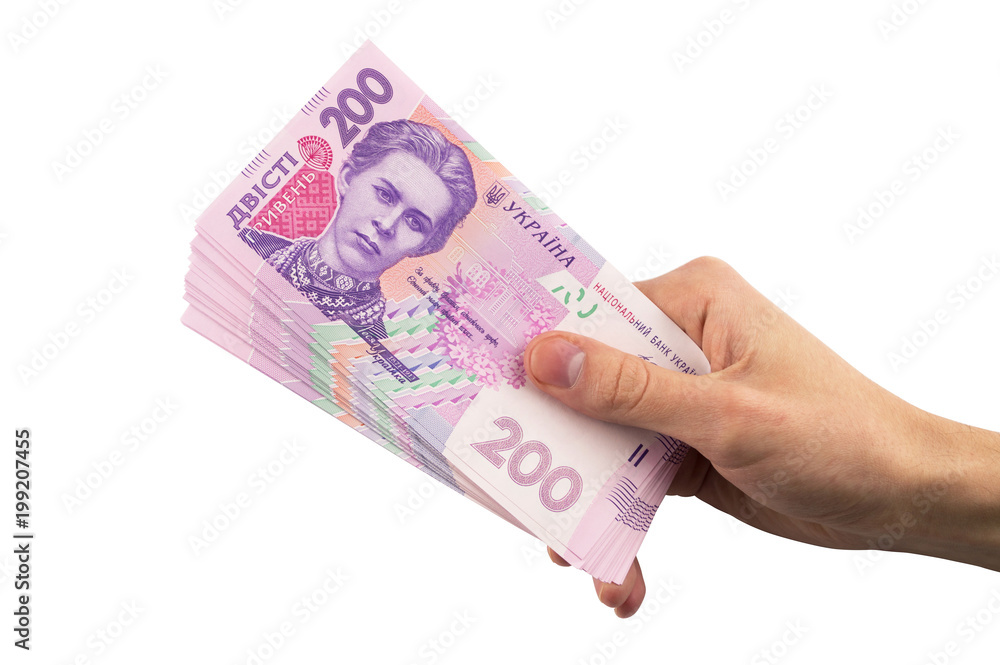 Ukrainian hryvnia currency. hand holding a pile of Ukrainian money isolated on white background Ukrainian hryvnia currency. hand holding a pile of Ukrainian money isolated on white background