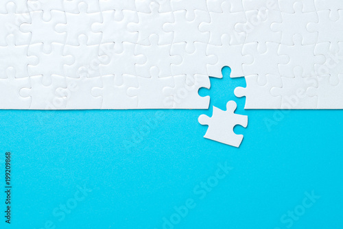 Fotografía Blue background made from white puzzle pieces and place for your content