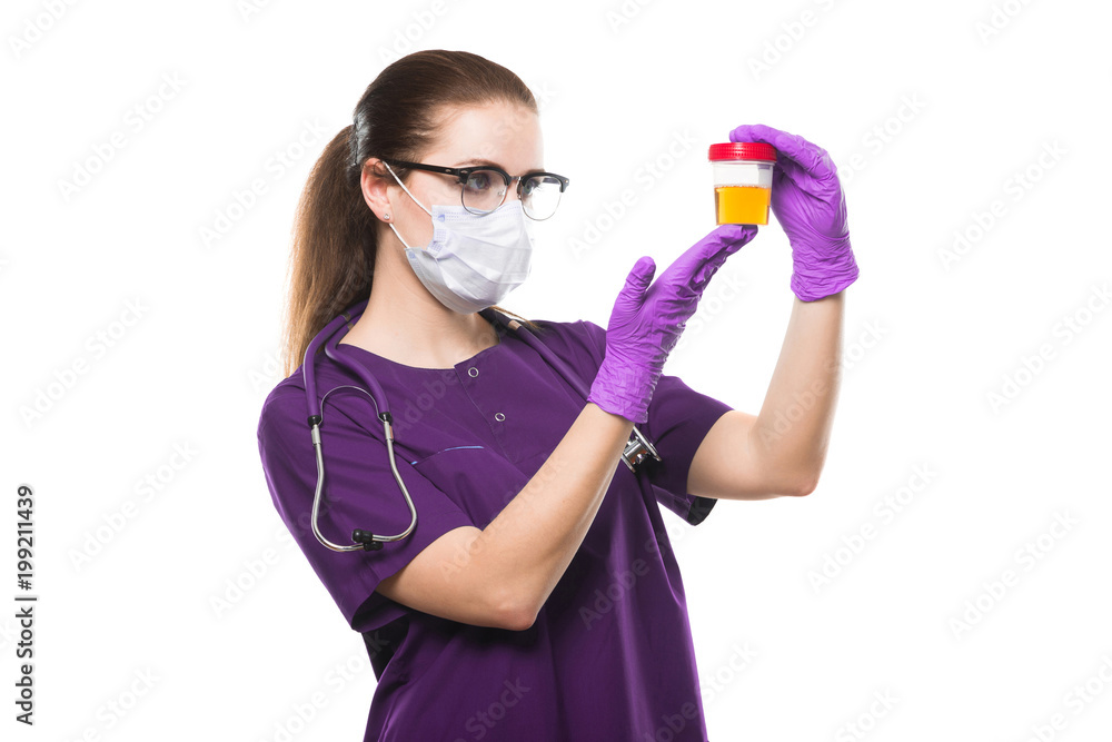 Attractive caucasian female doctor holding urine sample in her hands in medical mask and sterile gloves on white background Attractive caucasian female doctor holding urine sample in her hands in medical mask and sterile gloves on white background