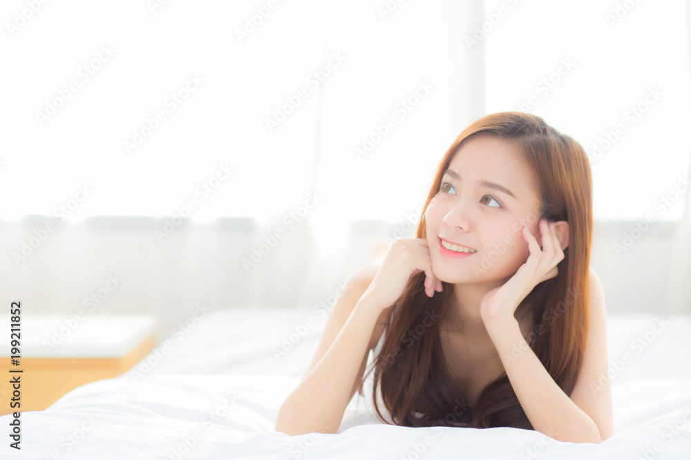 Beautiful portrait young asian woman lying and smile while wake up with sunrise at morning, lifestyle and relax concept. Beautiful portrait young asian woman lying and smile while wake up with sunrise at morning, lifestyle and relax concept.