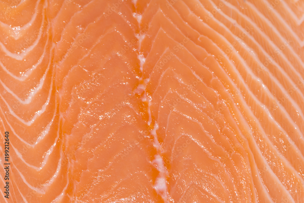 background, texture - fresh orange layered salmon fillet closeup