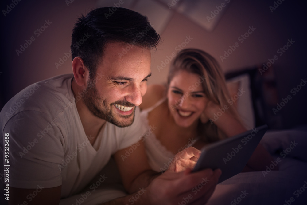 Young couple relaxing in bedroom Young couple relaxing in bedroom