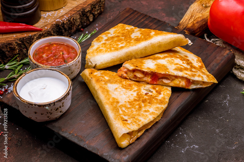 Quesadilla with chicken and sauces photo