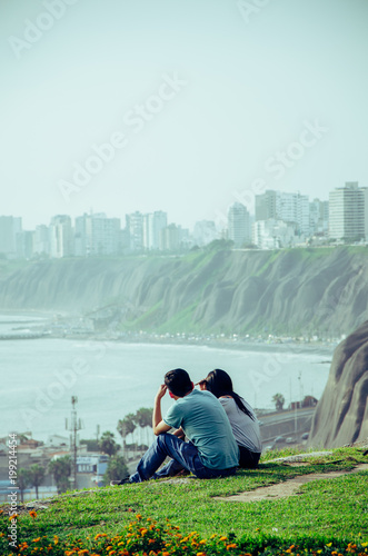 A couple sitting by the sea © Peruphotoart