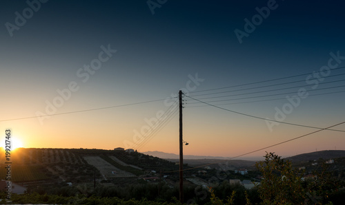 Silhouette of agricultural field and power line, Crete, Greece