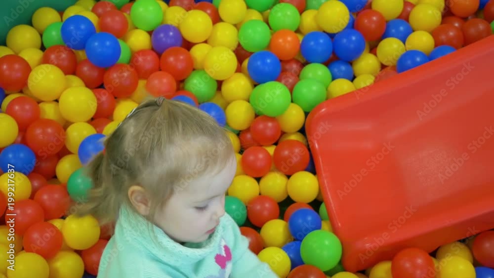 Cute little girl plays in the kindergarten. Cute little girl plays in the kindergarten.