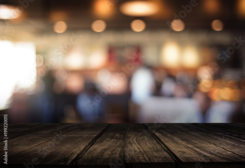 Wooden board empty table cafe, coffee shop, bar blurred background can be used for display or montage your products and Mock up