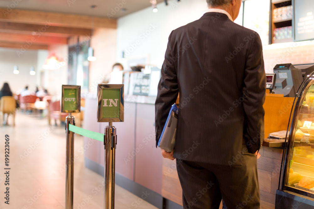 Selected focus silver post with text business man in line for a coffee Selected focus silver post with text business man in line for a coffee