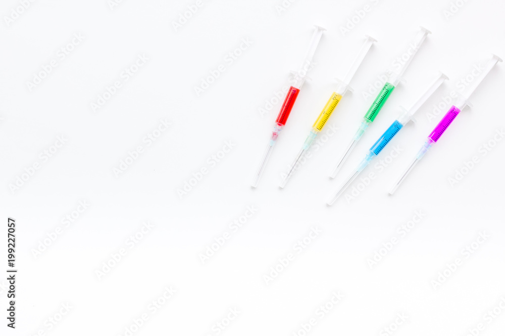 Syringe with colored drug. Injection concept on white background top view copy space Syringe with colored drug. Injection concept on white background top view copy space