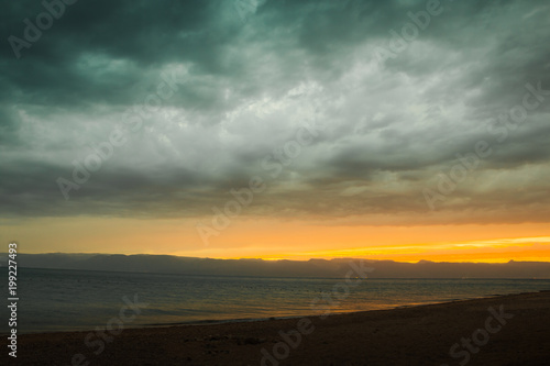 Line of sunset over the sea and sky with clouds © keleny