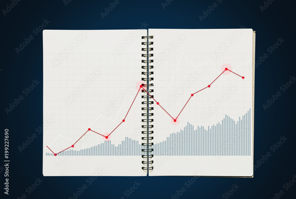 Raising graph on opened notebook, on blue background Raising graph on opened notebook, on blue background