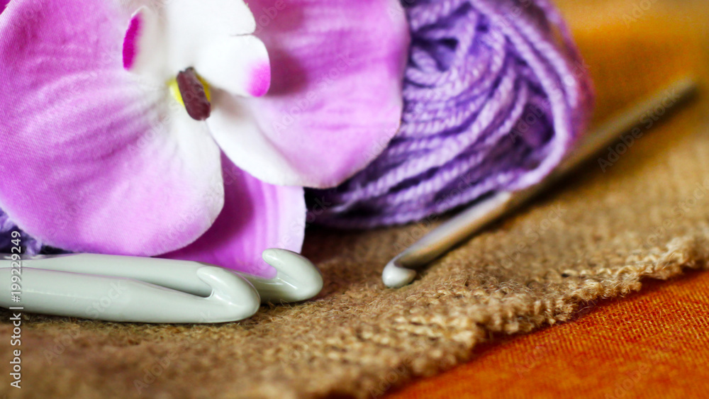 Hooks for knitting, purple yarn, and a beautiful Orchid Hooks for knitting, purple yarn, and a beautiful Orchid