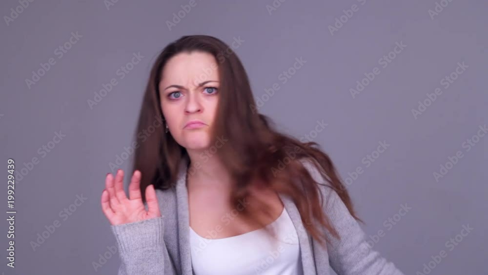 Woman walking than looking at the mirror and correcting hairstyle Woman walking than looking at the mirror and correcting hairstyle