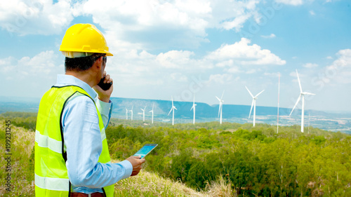 Male Engineer or tecnician at Work wind turbine station,wind enegy concept photo