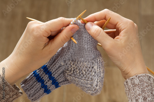woman hands knitting a sock