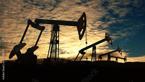 Working oil pump jacks against evening cloudscape time lapse