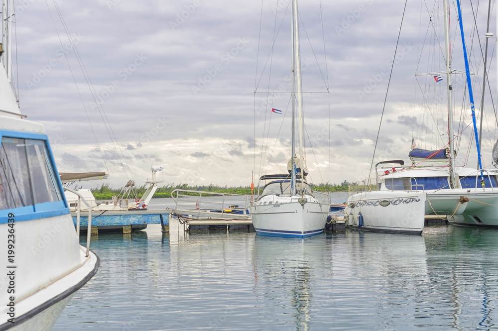Fototapeta premium Berth with moored nameless yachts against