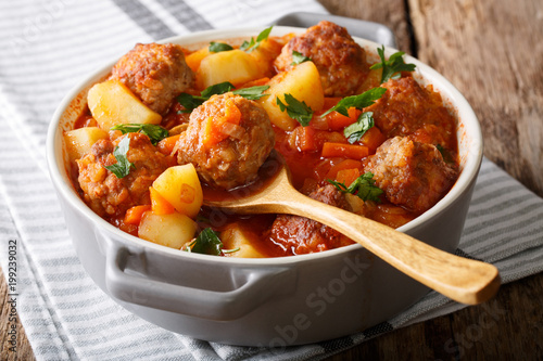 Принти на полотні Hot stew meatball soup with vegetables in tomato sauce closeup in a pot