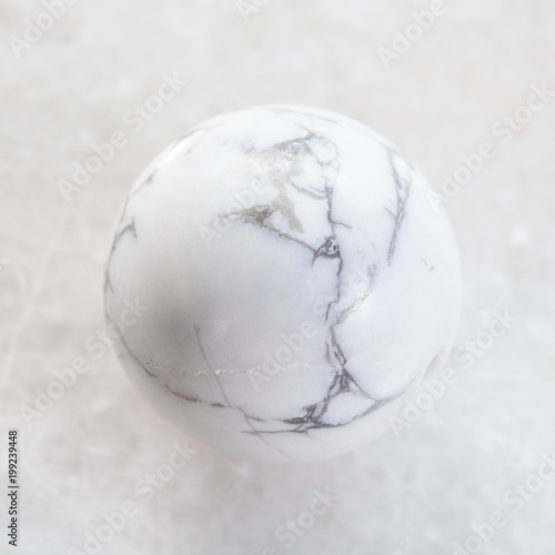 ball from Howlite gemstone on white marble