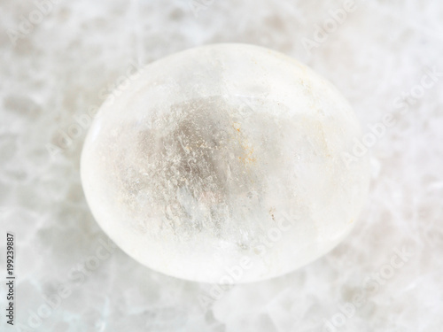 polished white agate gemstone on white marble