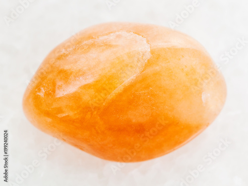 polished yellow aventurine gemstone on white photo