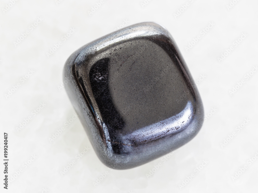 polished hematite stone on white marble polished hematite stone on white marble