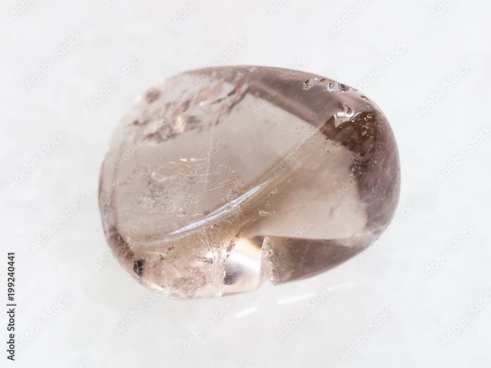 tumbled smoky quartz gemstone on white marble tumbled smoky quartz gemstone on white marble