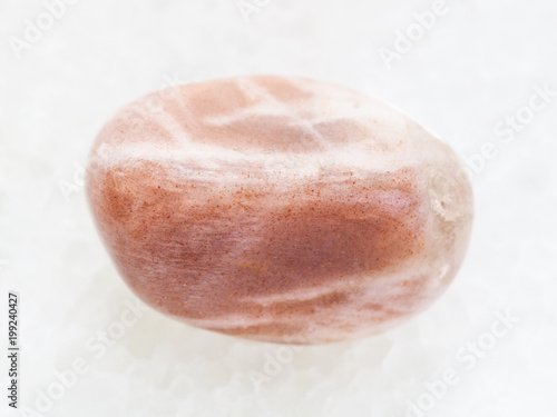 tumbled moonstone gemstone on white marble