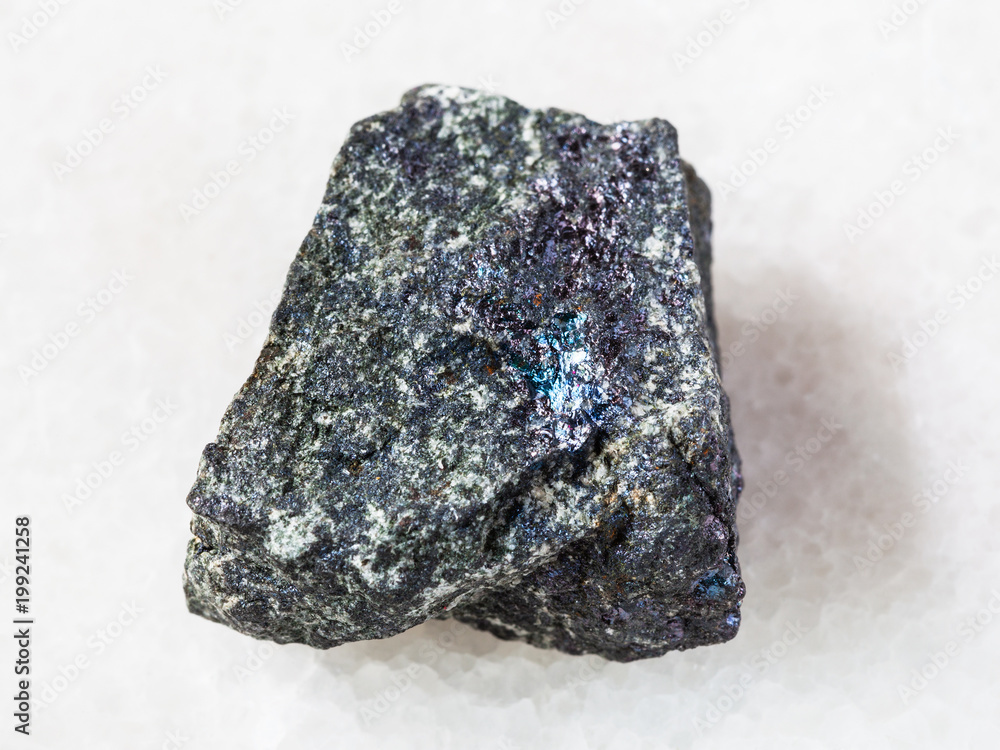 rough bornite stone on white marble rough bornite stone on white marble