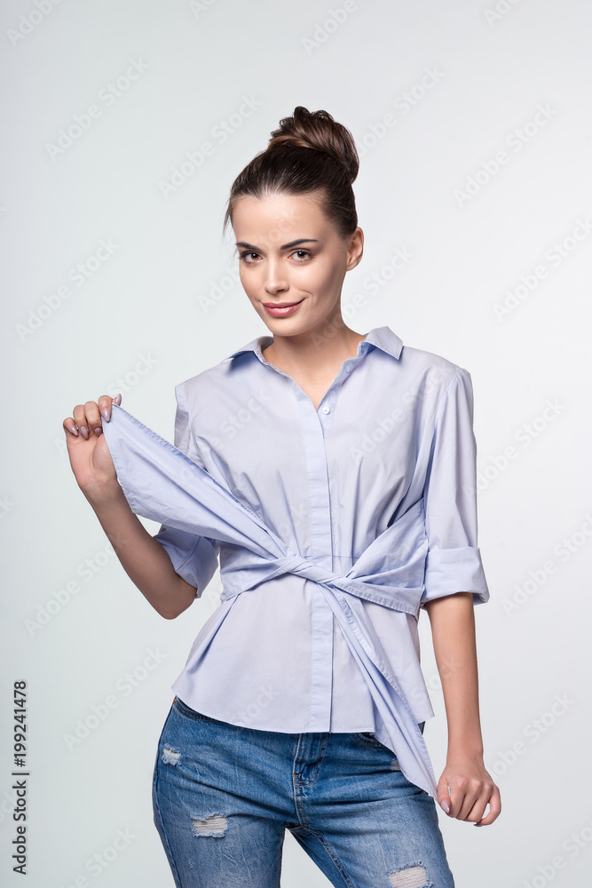 Fashion portrait of young elegant woman. Studio shot at grey background Fashion portrait of young elegant woman. Studio shot at grey background