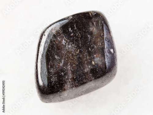 polished anthophyllite gemstone on white photo